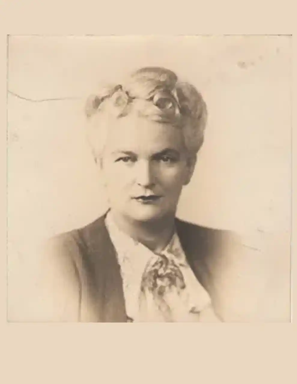 Small portrait of a woman in a ruffled blouse, mid-1940s.